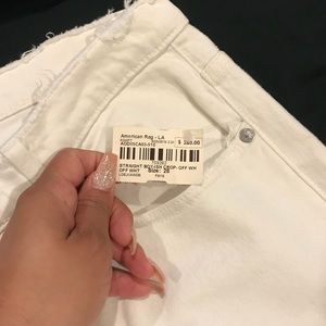 Distressed white jeans